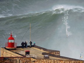 Big-wave surfer Garrett McNamara drops in on a large wave at Praia do Norte in Nazare January 28, 2013 in this handout photo provided by To Mane January 29, 2013. (REUTERS)
