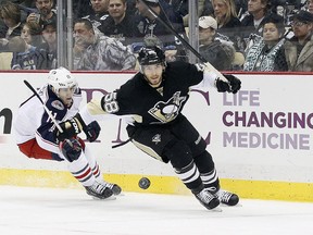 Pittsburgh Penguins defenceman Kris Letang (58) chases a loose puck ahead of Columbus Blue Jackets left wing Matt Calvert (11) during the second period at the CONSOL Energy Center earlier this season. (Charles LeClaire-USA TODAY Sports)