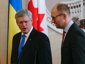 Ukrainian Prime Minister Arseny Yatseniuk (R) meets with Canadian Prime Minister Stephen Harper in Kiev, March 22.   
REUTERS/Gleb Garanich