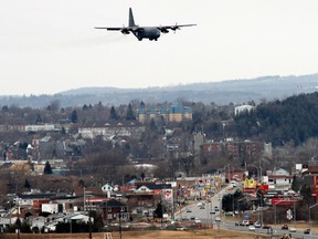 A C-130J Hercules flies over the east end of Trenton, Ont. as it is about to land back to its home base at 8 Wing/CFB Trenton Monday, April, 7, 2014. -    Jerome LessardThe Intelligencer/QMI Agency