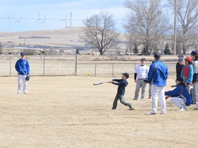 A young attendee of the Pincher Creek Minor Baseball spring training camp swings for the fence.