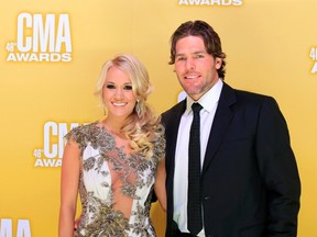 Former Senator Mike Fisher and country music superstar Carrie Underwood. (Reuters)