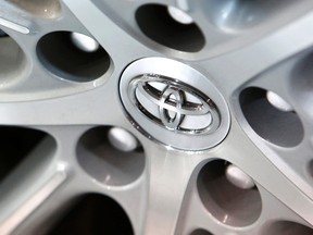 A Toyota Motor Corp logo is pictured on the wheel of a car at its showroom in Tokyo in this February 4, 2014 file photo. (REUTERS/Yuya Shino/Files)
