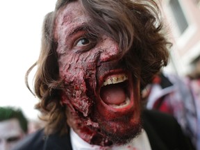 A man dressed as a zombie takes part in a "Zombie Walk", part of the Venetian Carnival, in Venice February 15, 2014. (REUTERS/Max Rossi)