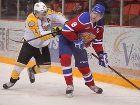 Griffin Reinhart battles Wheat Kings winger Jens Meilleure during Tuesday's game in Brandon. (Bruce Bumstead, Brandon Sun)