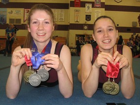 Moira Trojans teammates Victoria Armstrong (left) and Kailyn Maracle combined to win five medals at the OFSAA gymnastics championships this week in Peterborough. (PHOTO SUBMITTED)