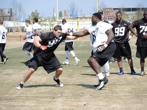 James Lee (67) trying to block defensive lineman Andrew Marshall at the RedBlacks mini camp in Virginia Wednesday. Tim Baines/Ottawa Sun