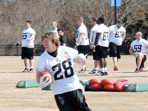 Running back Jordan Roberts carries the ball at the RedBlacks mini camp in Virginia Wednesday. Tim Baines/Ottawa Sun