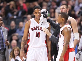 DeMar DeRozan gets some attention after taking an elbow in the eye during the second half of the Raptors’ game against the Philadelphia 76ers on Wednesday night. (Stan Behal/Toronto Sun)