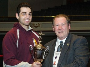 Tamerlan Tsarnaev, left, accepts the trophy for winning the 2010 New England Golden Gloves Championship in Lowell, Mass., from Dr. Joseph Downes in this February 17, 2010 handout photo. (REUTERS/Julia Malakie/The Sun of Lowell, Mass./Handout)