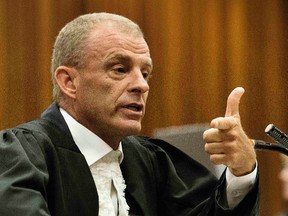 State prosecutor Gerrie Nel gestures as he cross examines South African Olympic and Paralympic track star Oscar Pistorius during his ongoing murder trial in Pretoria, Thursday, April 10, 2014. (Marco Longari/Reuters/Pool)