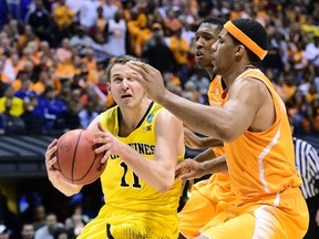 Michigan Wolverines guard Nik Stauskas (11) drives to the basket against Tennessee Volunteers forward Jarnell Stokes (right) in the second half in the semifinals of the midwest regional of the 2014 NCAA Mens Basketball Championship tournament at Lucas Oil Stadium. (Bob Donnan-USA TODAY Sports)