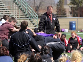 Richard Cooke, assistant coach for the Sarnia Saints men's rugby team, instructs over 200 high school girls on facets of the sport to increase their skill level as well as help prevent injuries at a clinic at Norm Perry Park on Thursday, April 10. The high school rugby season is set to get underway next week. SHAUN BISSON/THE OBSERVER/QMI AGENCY
