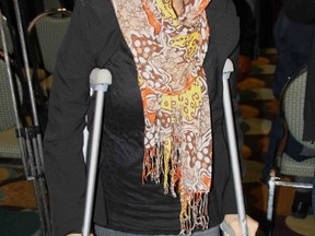 York University student Qurratul "Annie" Ain Malik walks into the press conference with the aid of crutches. The main plaintiff in  $20.5 million lawsuit still has a bullet lodged in her leg from the shooting from last month's shooting near the school's student centre. (CHRIS DOUCETTE/Toronto Sun)