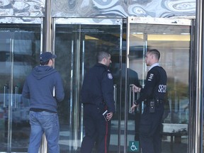 A police officer enters the building a day after Wednesday's multiple stabbing at an office in 4110 Yonge St. (VERONICA HENRI/Toronto Sun)