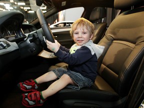 Domenico Barone, 2, gets behind the wheel of a 2014 BMW 535i xDrive M Sport Sedan, while checking out the Edmonton Motorshow with his father, at the Edmonton Expo Centre on Thursday. The Motorshow runs through Sunday. David Bloom/Edmonton Sun/QMI Agency