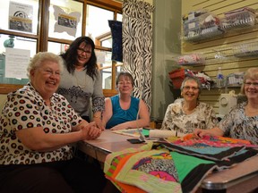 Volunteers with the Zebra Quilting Club of Alberta squeeze into their tiny office inside the Heritage Market Mall in Stony Plain. - Thomas Miller, Reporter/Examiner