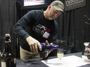 Mark Vansteenkiste pours a glass of fruit cider at the fourth annual Fusion food and wine show at the RBC Centre Friday. Twin Pines Orchards and Cider House, owned by Vansteenkiste with his brother Mike, is one of 46 food and wine vendors at the event, continuing today from 3 p.m. to 10 p.m. (TYLER KULA, The Observer)