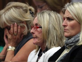 June Steenkamp (centre), mother of Reeva Steenkamp, watches with family friends as Olympic and Paralympic track star Oscar Pistorius speaks in a Pretoria court on April 11, 2014. (Themba Hadebe/Reuters/Pool)
