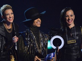 Prince and his band 3rdEyeGirl present the award for British Female Solo Artist at the BRIT Awards, celebrating British pop music, at the O2 Arena in London February 19, 2014. (REUTERS/Toby Melville)