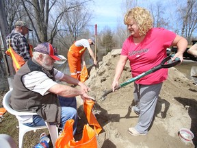 River Road residents in Foxboro, Ont., Chris Berry and sister Lisa Long, are busy sandbagging Friday afternoon, April, 2014. - Luke Hendry/The Intelligencer