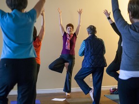 Catherine Heighway co-owner of Spanda Yoga and Retreats leads workshop participants during a fundraising day at their yoga studio located in London's west end. Combined the participants raised $1200, $200 more than their goal of $1000. (MARK SPOWART, The London Free Press)