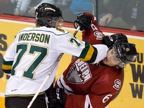 London Knights? Josh Anderson gets his arm in the face of the Storm?s Phil Baltisberger duringthe second period of Game 5 of the OHL Western Conference semifinal in Guelph on Friday night. (DEREK RUTTAN, The London Free Press)