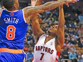 Raptors guard Kyle Lowry has his shot defended by Knicks' J.R. Smith during Friday night's game. (STAN BEHAL/Toronto Sun)