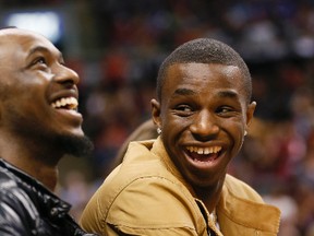 Andrew Wiggins (right) and his brother, Nick, enjoy courtside seats at the Raptors game at the ACC last night. (Stan Behal/Toronto Sun)