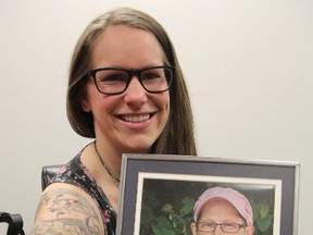 Ashlee Mills, 25, holds a picture of her late mother Mercedes, who died after losing her battle with cancer in March. Mills, who has several tattoos commemorating her mom, is shaving her head this Mother's Day to raise money for her Relay for Life team, Mercede's Angels. TYLER KULA/ THE OBSERVER/ QMI AGENCY