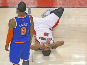 Raptors’ DeMar DeRozan lays on the court after getting knocked down against New York Knicks’ J.R. Smith on Friday night. (USA TODAY SPORTS)