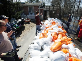 Brendan Andrews, third from right, gets plenty of help to sandbag around his Hamorny Road house in Foxboro, Ont. Saturday, April 12, 2014. - Jerome Lessard/The Intelligencer/ QMI Agency