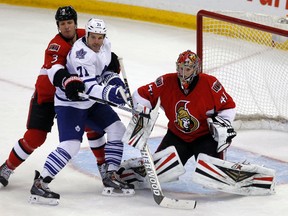 Ottawa Senators defenceman Marc Methot ties up Maple Leafs forward David Clarkson on Saturday night in Ottawa. (Darren Brown/QMI Agency)