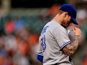 Brett Lawrie of the Toronto Blue Jays fixes his necklace before playing the Baltimore Orioles at Camden Yards on April 12, 2014. (Patrick Smith/Getty Images/AFP)
