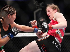 Sarah Kaufman (red gloves) fights against Jessica Eye (blue gloves) in their women's bantamweight bout during UFC 166 at Toyota Center. (Andrew Richardson/USA TODAY Sports)