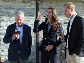 Britain's Prince William (R) and his wife Catherine, the Duchess of Cambridge (C), chat to John Darby (L), co-owner of the Amisfield Winery during a visit to the winery in Queenstown on April 13, 2014. Britain's Prince William, his wife Kate and their son Prince George are on a three-week tour of New Zealand and Australia. (AFP PHOTO/POOL/CRAIG BAXTER)