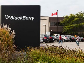 People walk through a parking lot at the Blackberry campus in Waterloo in this September 23, 2013 file photo. REUTERS/Mark Blinch/Files