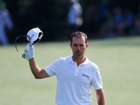 Mike Weir of Bright's Grove salutes the gallery while walking up the 18th hole at August National during the second round of the 2014 Masters Tournament on Friday. While Weir had a disappointing weekend at the tournament, he took strides forward, making just his 2nd appearance on the weekend in the 2014 season. (Rob Carr/Getty Images​)