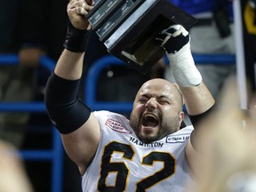 Hamilton's Marwan Hage holds the trophy and is going to the Grey Cup.  Argos lost to Hamilton 36-24 on Sunday November 17, 2013. Craig Robertson/Toronto Sun/QMI Agency