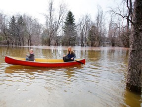 River Road resident in Corbyville, Ont. Angela Terrence and Tristan Czulo paddle along her property's driveway and across her front yard in order to access her vehicle, Sunday, April 13, 2014.  - Jerome Lessard/The Intelligencer/ QMI Agency