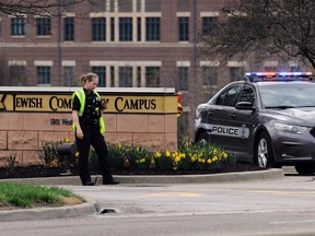 An Overland Park Kansas police officer guards the entrance to the scene of a shooting at the Jewish Community Center of Greater Kansas City in Overland Park, Kansas April 13, 2014.  REUTERS/Dave Kaup