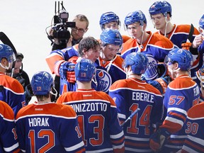Ryan Smyth (94) is congratulated by Edmonton Oilers teammates at the end of his last game in the NHL at Rexall Place in Edmonton, Alta., on Saturday, April 12, 2013. The Oilers beat the Vancouver Canucks 5-2. Ian Kucerak/Edmonton Sun/QMI Agency