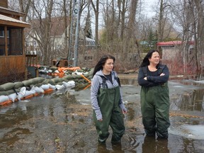 Jennifer Rochefort, left, and Jennifer Chiabai have been working round-the-clock sandbagging to keep floodwaters at bay around Rochefort's home on Fennell Lane near Kars. 
MEGAN GILLIS/OTTAWA SUN/QMI AGENCY