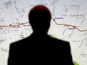 Enbridge counsel Rick Neufeld is silhouetted against a map of the Northern Gateway pipeline, as he takes part in the Enbridge Northern Gateway Project Joint Review Panel hearings in Edmonton on Sept. 4, 2012. (DAVID BLOOM/QMI AGENCY)