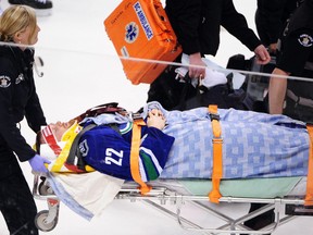Vancouver Canucks forward Daniel Sedin (22) is taken by stretcher off the ice after a hit by the Calgary Flames during the second period at Rogers Arena. (Anne-Marie Sorvin-USA TODAY Sports)