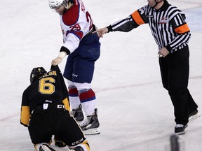 Mitch Moroz holds his right hand over the Brandon Wheat Kings’ Ryan Pilon late in the third period  at Rexall Place on Friday, but doesn’t unload. The Oil Kings eliminated the Wheaties with a 5-1 Game 5 win. DAVID BLOOM Edmonton Sun