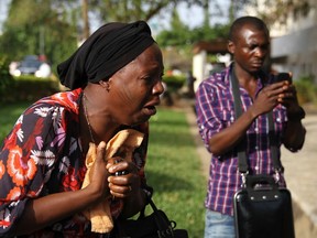 A bystander reacts as she sees victims of a bomb blast arriving at the Asokoro General Hospital in Abuja on April 14, 2014. (REUTERS/Afolabi Sotunde)