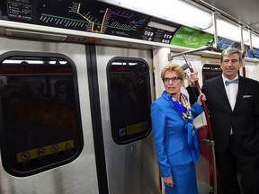 Premier Kathleen Wynne, left, and Minister of Infrastructure Glen Murray ride the subway while en route to Wynne's speech at the Toronto Region Board on Monday. (Darren Calabrese/CP Pool/QMI Agency)