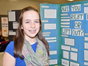 Madison McKellar, a Grade 7 student of St. Columban, stands with her science project “If you're right or left handed, how does that affect which side of your brain is more dominant?” WHITNEY SOUTH/QMI AGENCY
