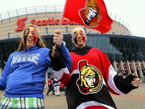 Sens fans Shelby Adams (L) and Samantha Green from Ogdensburg, NY cheer for their team before the Sens take on the Pittsburgh Penguins' at the NHL Eastern Conference Semifinal game at the Canadian Tire Centre on May 19,2013. Ottawa will not get the benefit of playoff tourists in 2014.
 Errol McGihon/The Ottawa Sun/QMI Agency